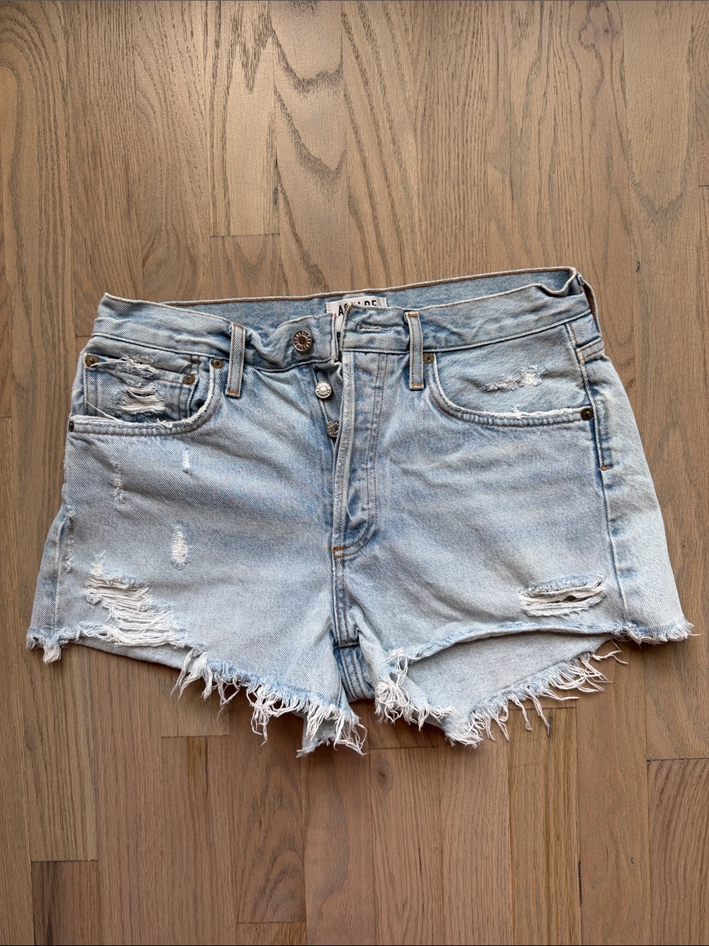 AGOLDE Parker Vintage  Light Wash Distressed Cutoff Jean Shorts 
Color in Broken